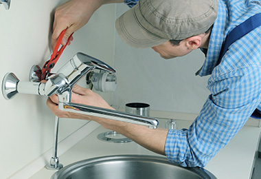 Male is installing shower faucet